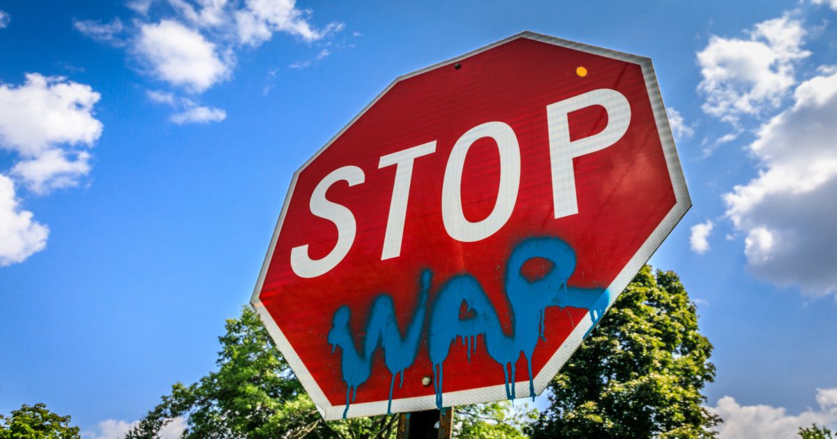 Stop sign War spray painted on